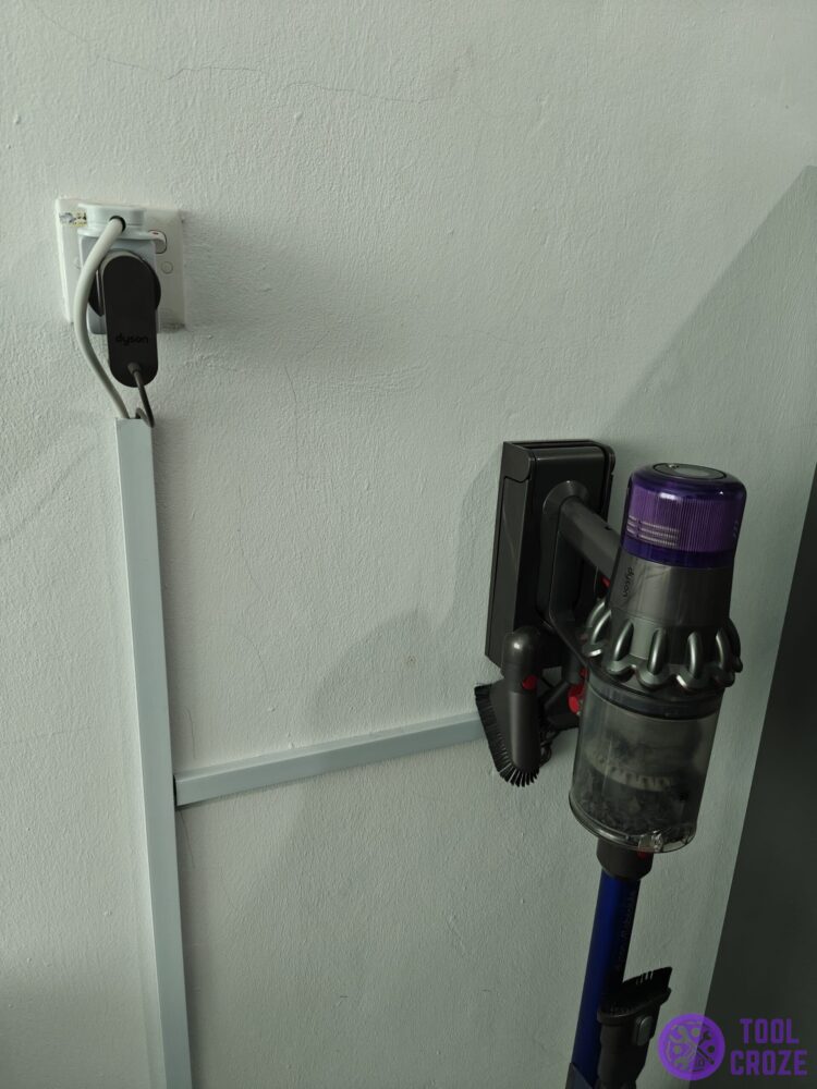 dyson vacuum plugged into charger
