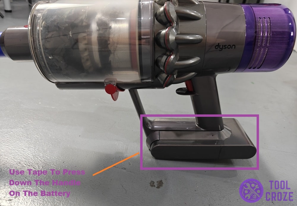 press handle down on battery