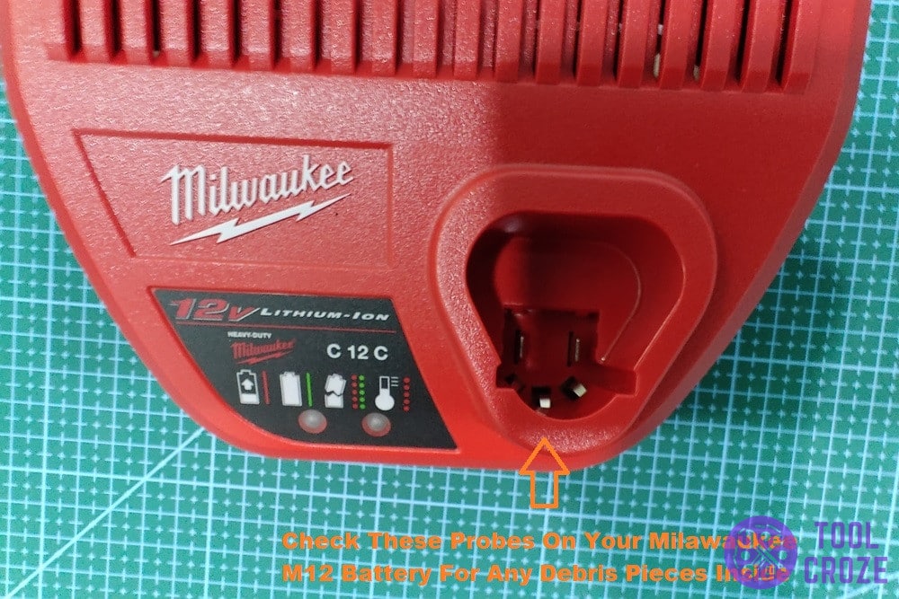 inspect milwaukee battery charger prongs for debris