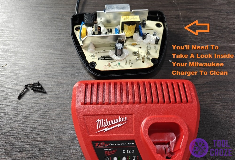 open the milwaukee charger and clean internally