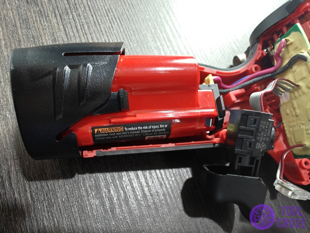 inside a Milwaukee M12 drill showing battery ad trigger mechanism