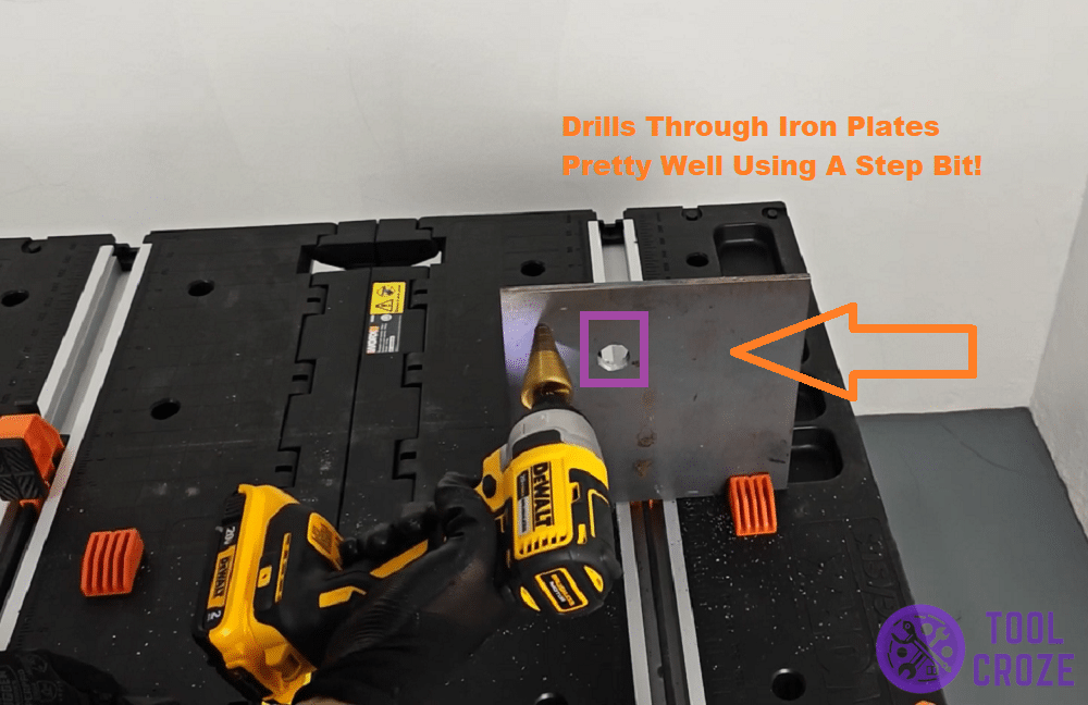 DeWALT-DCF787 with a step bit on iron plate