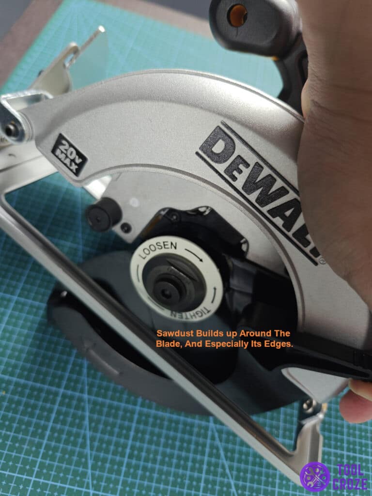 Sawdust builds up around the blade, and especially its edges.