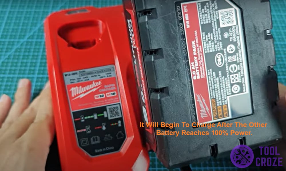 It will begin to charge after the other battery reaches 100% power.
