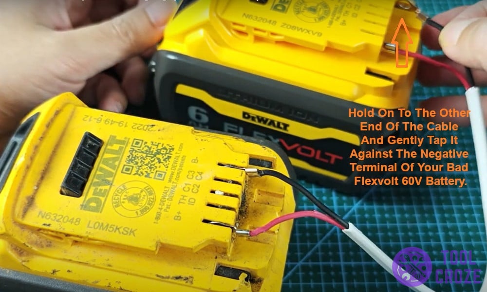 Gently tap it against the negative terminal of your bad Flexvolt 60V battery.