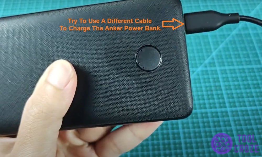 Try to use a different cable to charge the Anker power bank.