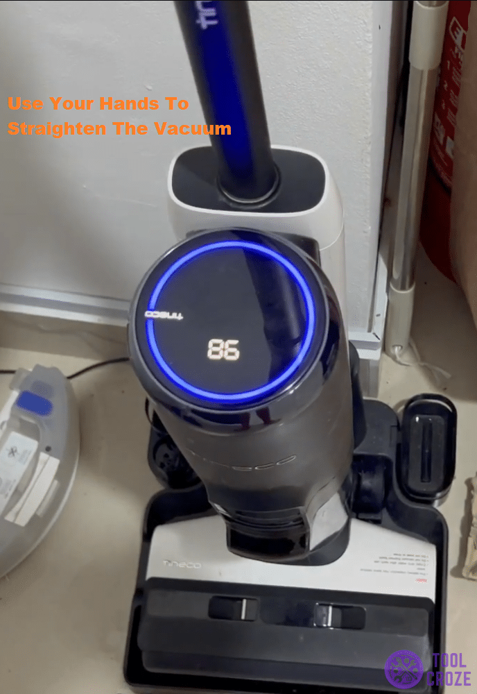 push the vacuum upward on the base