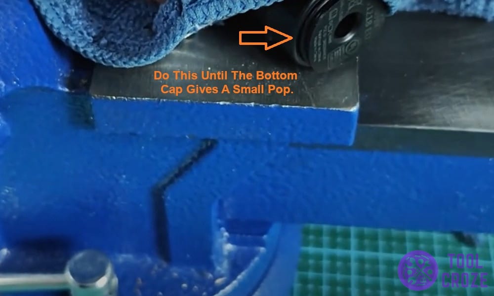Do this until the bottom cap gives a small pop.