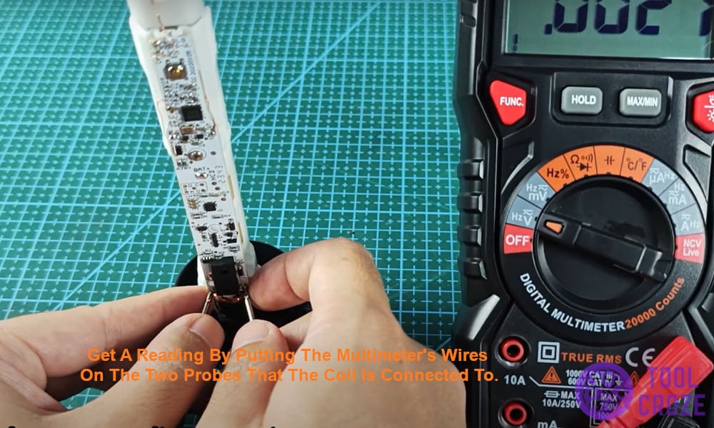 Get a reading by putting the multimeter's wires on the two probes that the coil is connected to.