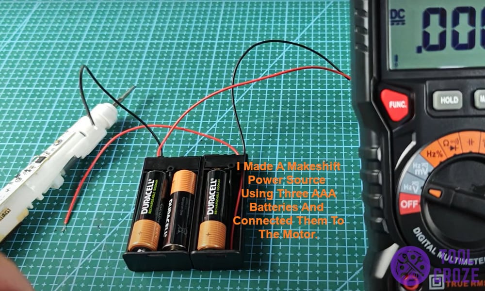 I made a makeshift power source using three AAA batteries and connected them to the motor.