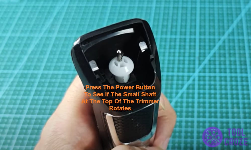 Press the power button to see if the small shaft at the top of the trimmer rotates.