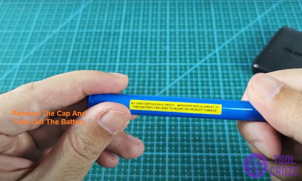 Remove the cap and take out the battery.