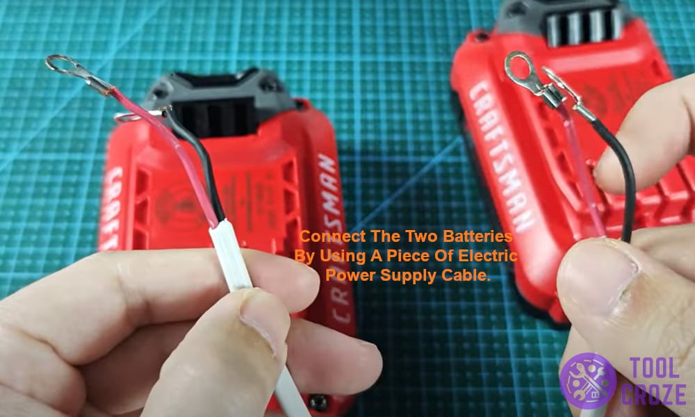 connect the two batteries by using a cable.