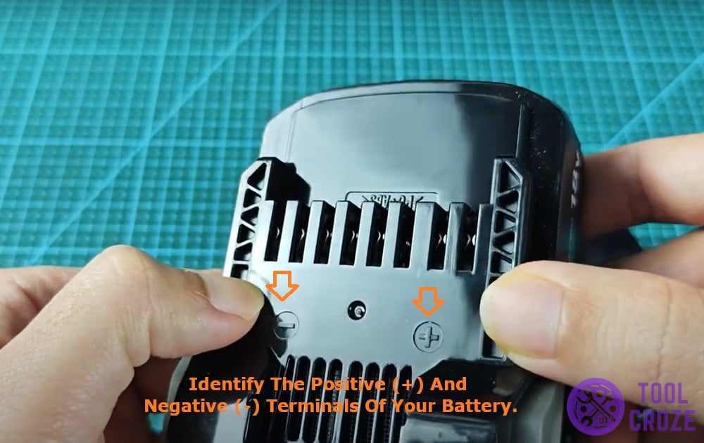 identify the positive (+) and negative (-) terminals of your battery.