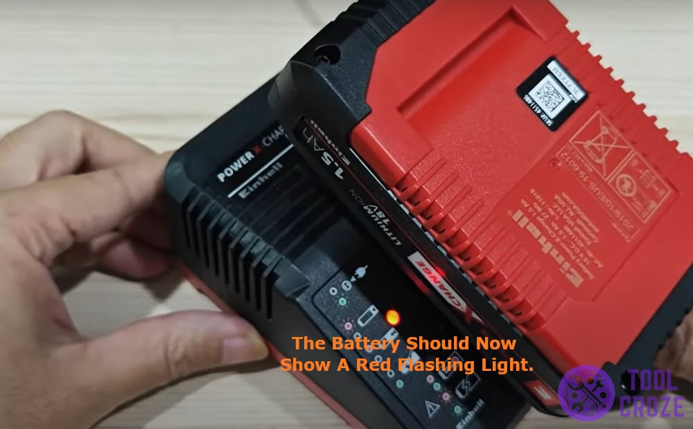 the battery should now show a red flashing light.