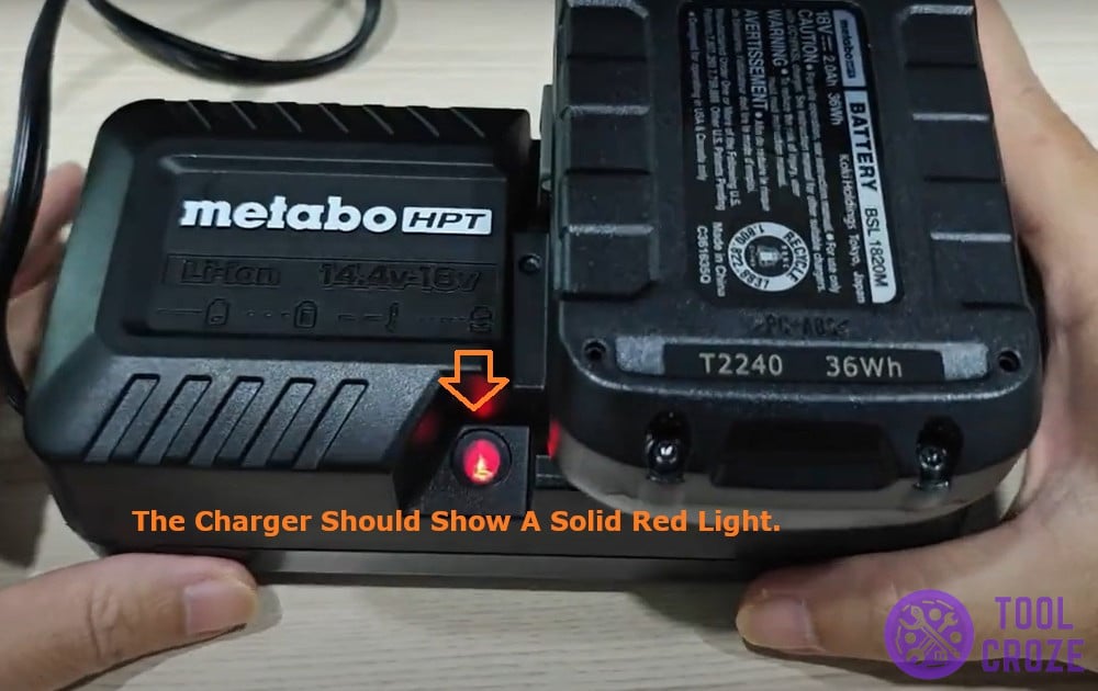 the charger should show a solid red light
