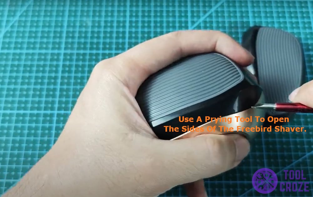 use a prying tool to open the sides of the Freebird Shaver.