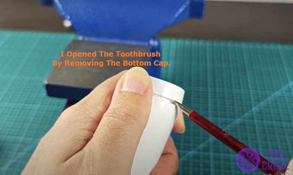 I opened the toothbrush by removing the bottom cap.