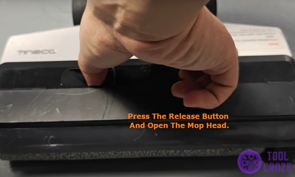 press the release button and open the mop head