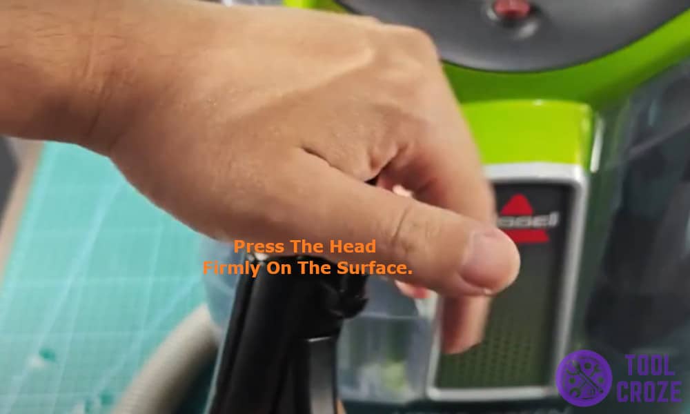 pressing the head firmly on the surface