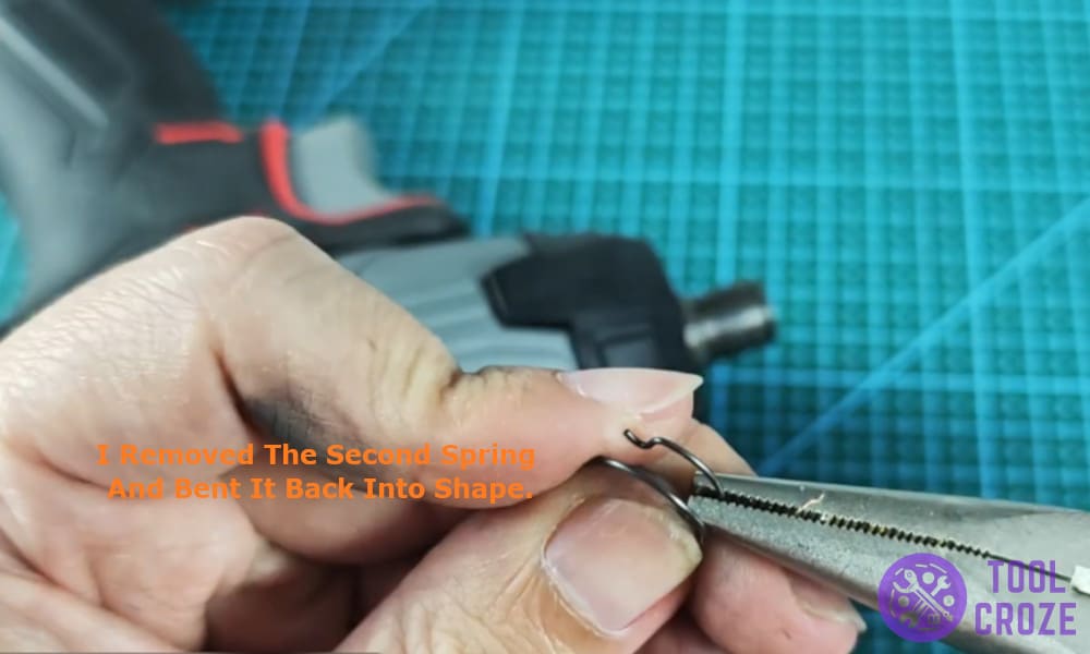 I removed the second spring and bent it back into shape.