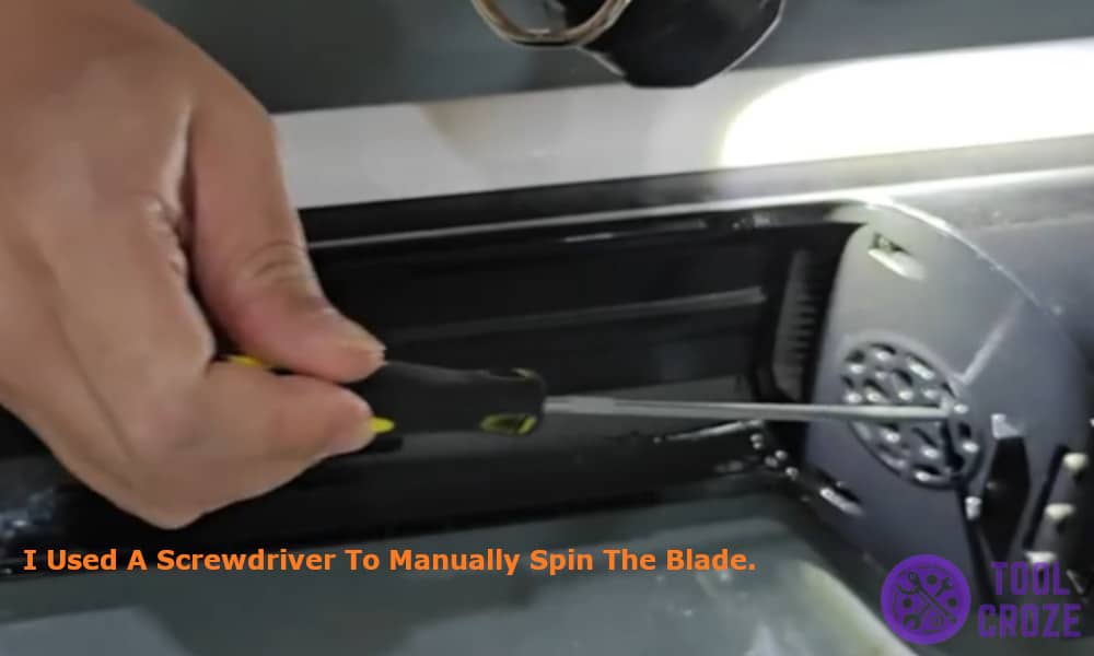 I used a screwdriver to manually spin the blade
