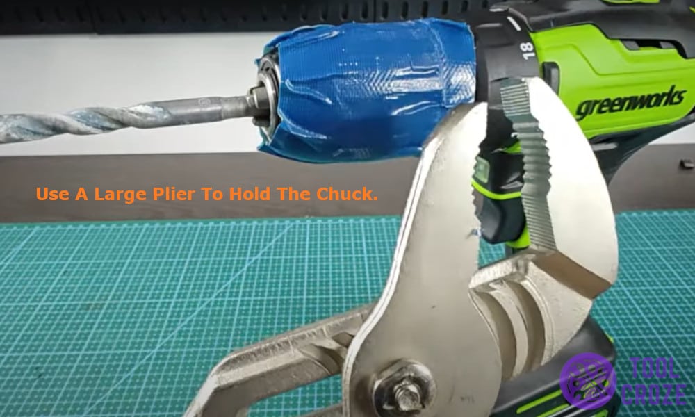 Use a large plier to hold the chuck