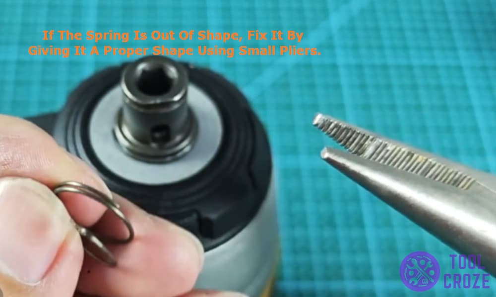 if the spring is out of shape and fix it by giving it a proper shape using small pliers.