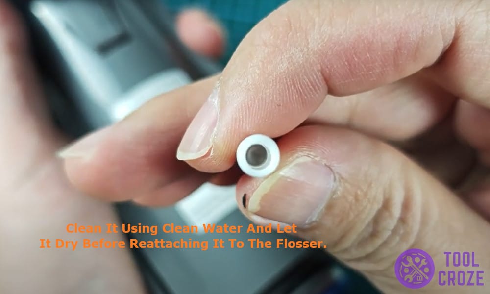 Clean it using clean water and let it dry before reattaching it to the flosser.