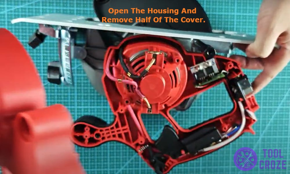 opening the housing and removing half of the cover