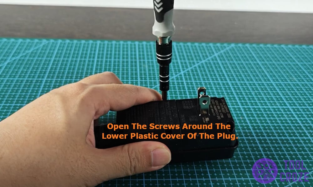 opening the screws around the lower plastic cover of the plug.