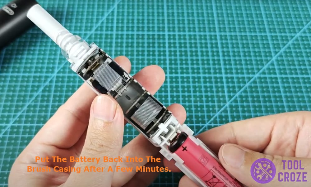 put the battery back into the brush casing