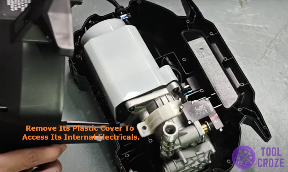 removing its plastic cover to access its internal electricals.