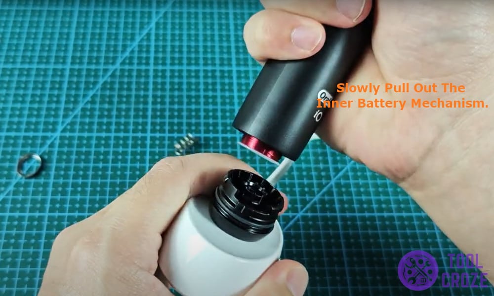 slowly pull out the inner battery mechanism