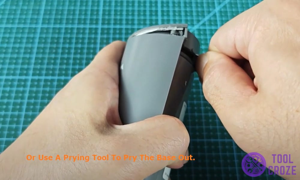 use a prying tool to pry the base out.