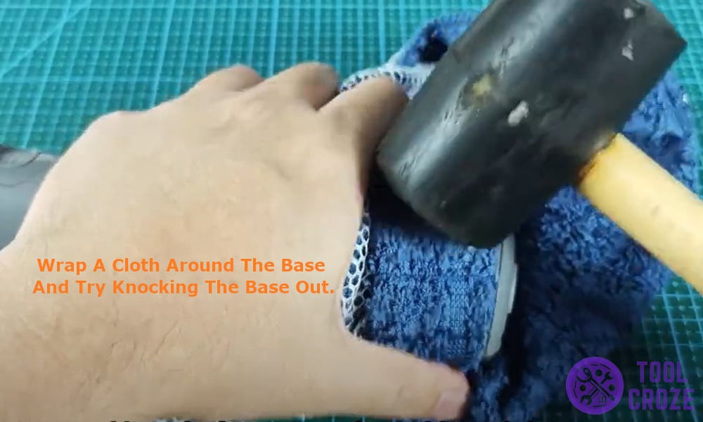 wrapped a cloth around the base and tried knocking the base out
