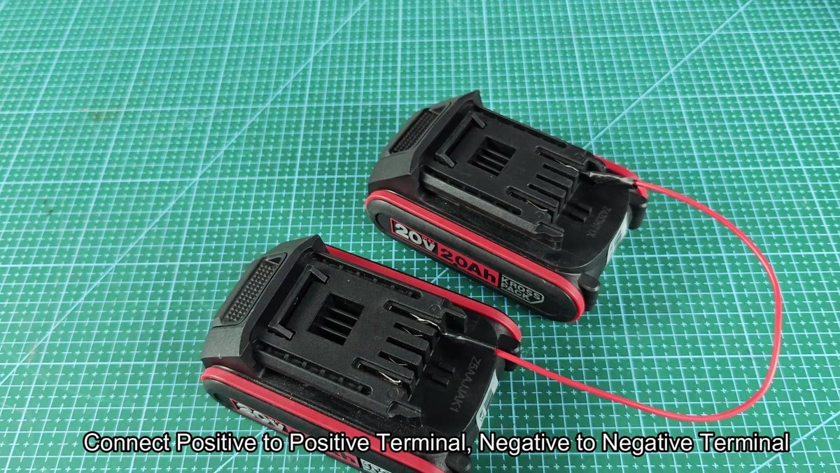 20V battery packs on green grid mat