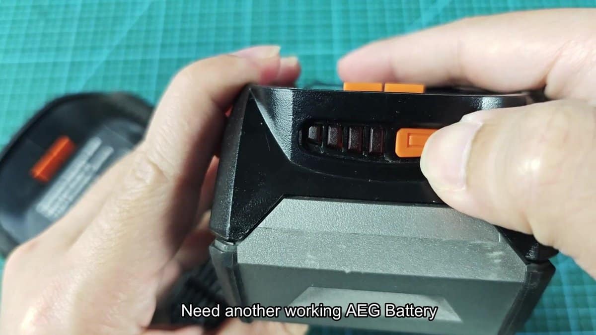 AEG battery with orange release button pressed