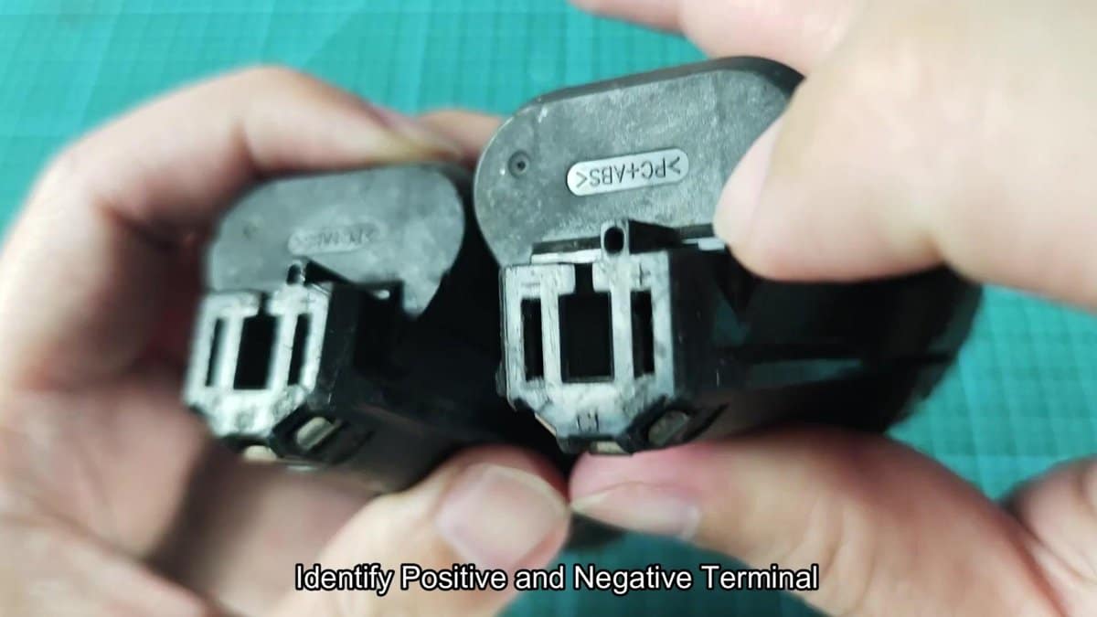 Battery terminals showing polarity labels
