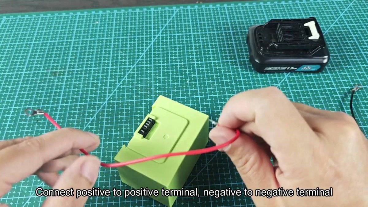 Battery with wires being connected on cutting mat