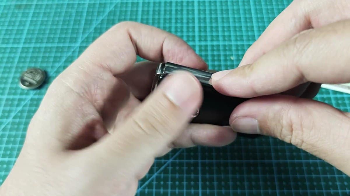 Black battery cover being snapped shut