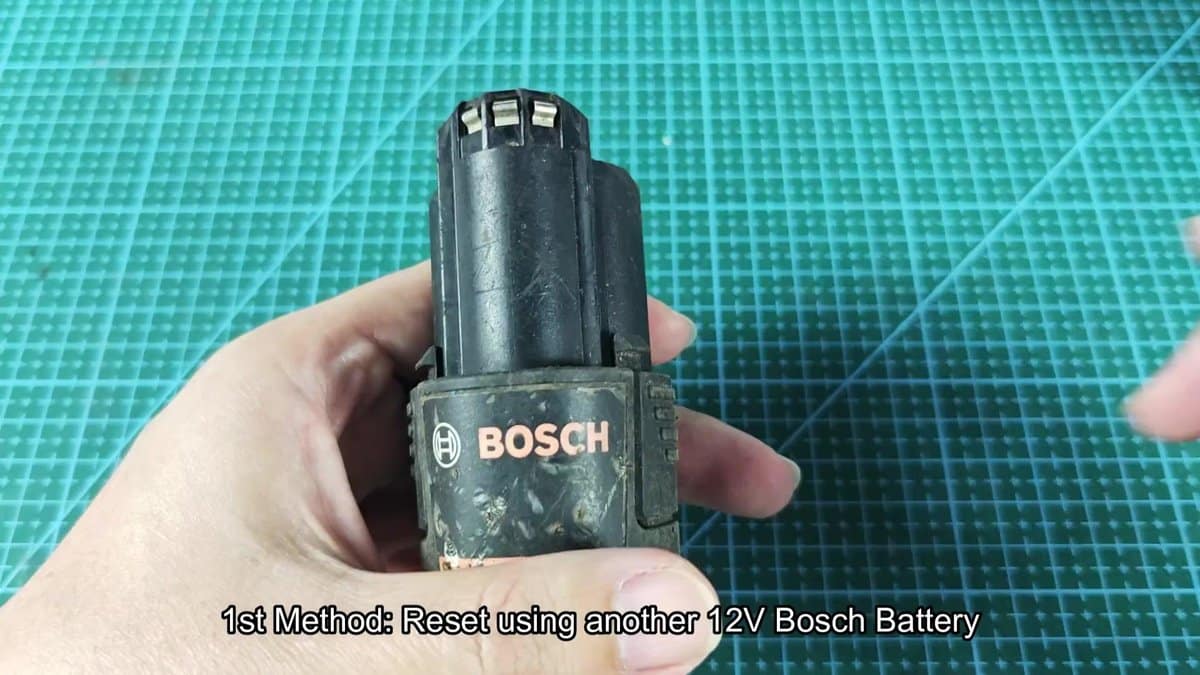 Bosch 12V battery on green grid surface