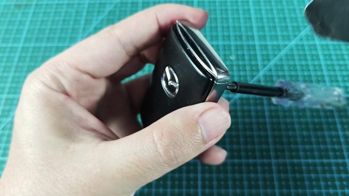 Car key fob with small screw being adjusted