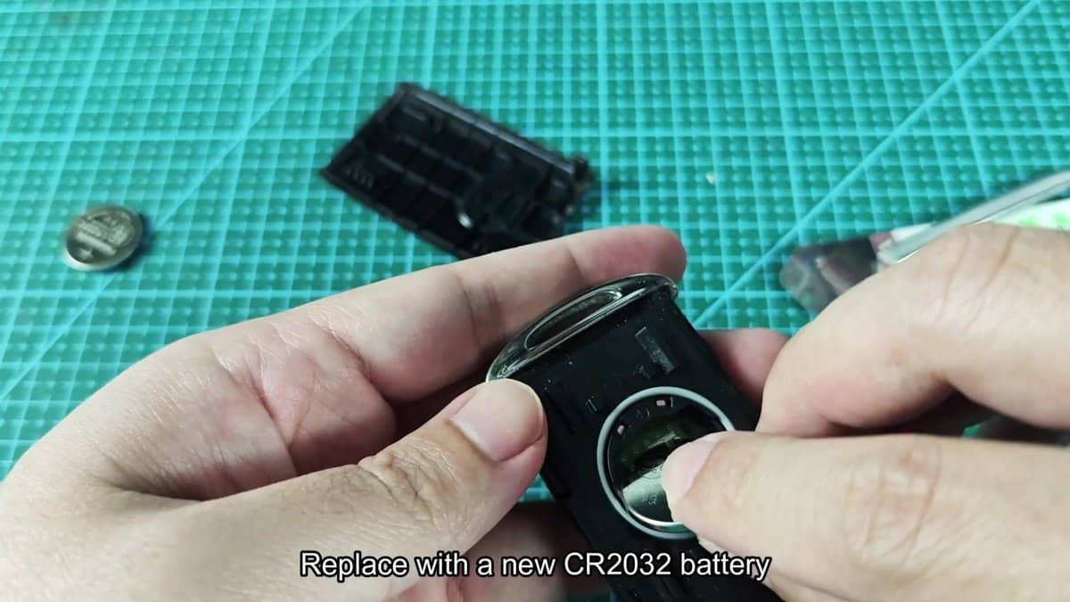 CR2032 battery being inserted into device