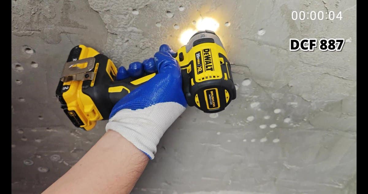 DeWalt 20V drill operating on concrete wall