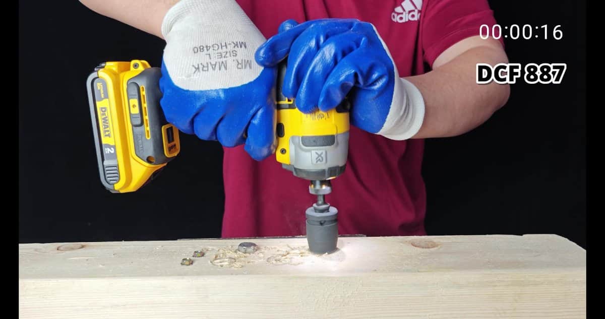 DeWalt DCF 887 drilling into wooden board