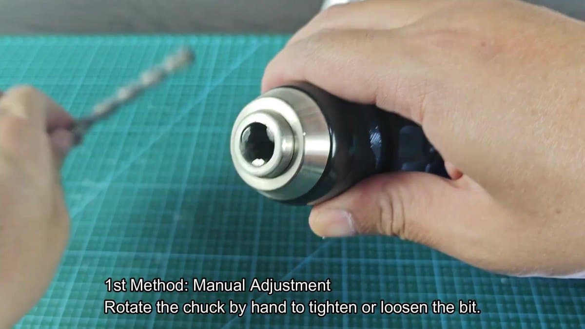 Drill chuck being manually adjusted