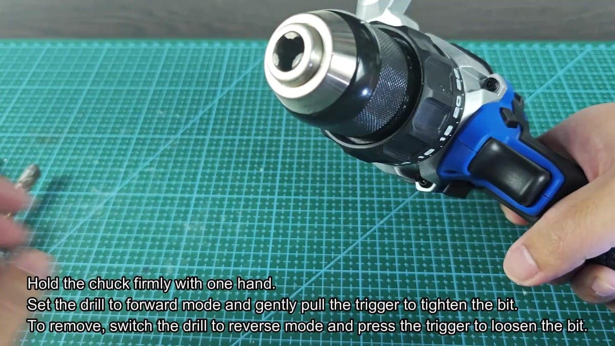 Electric drill with metal chuck on green mat