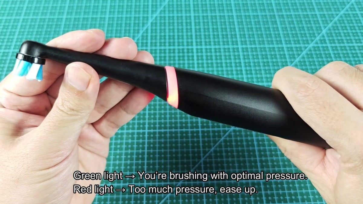 Electric toothbrush with red pressure light