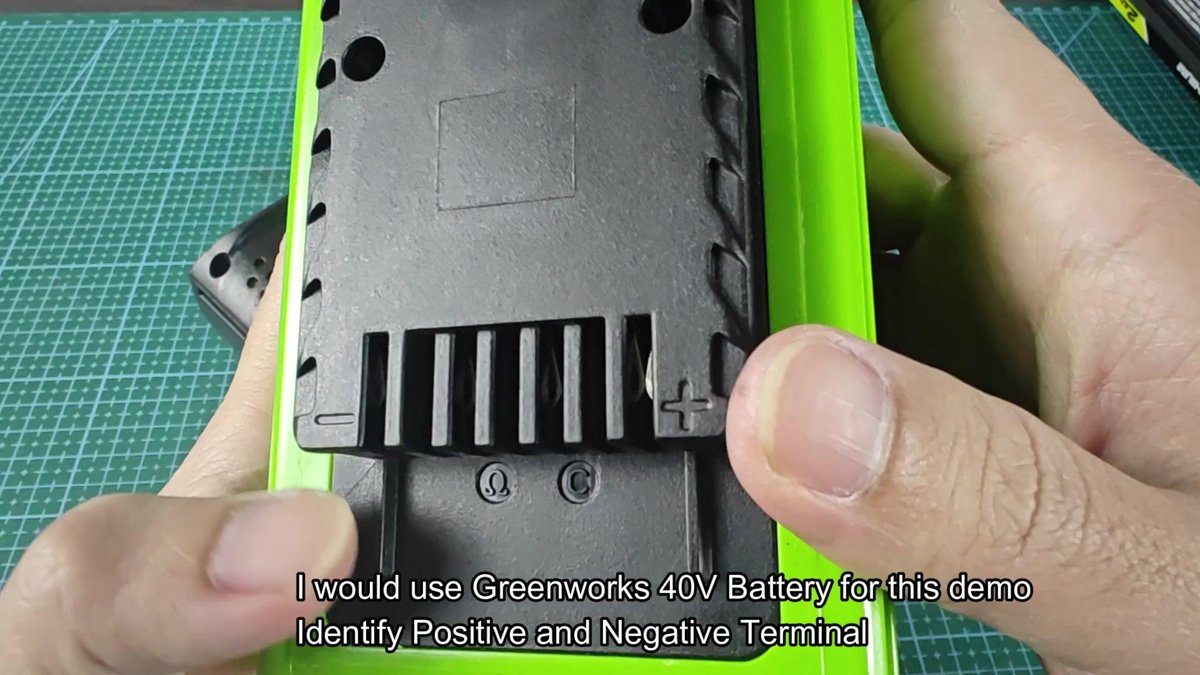 Greenworks 40V battery terminals labeled plus and minus